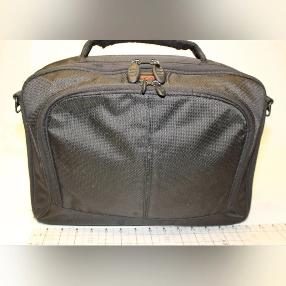 TUMI Black Backpack with Padded Straps and Multiple Compartments